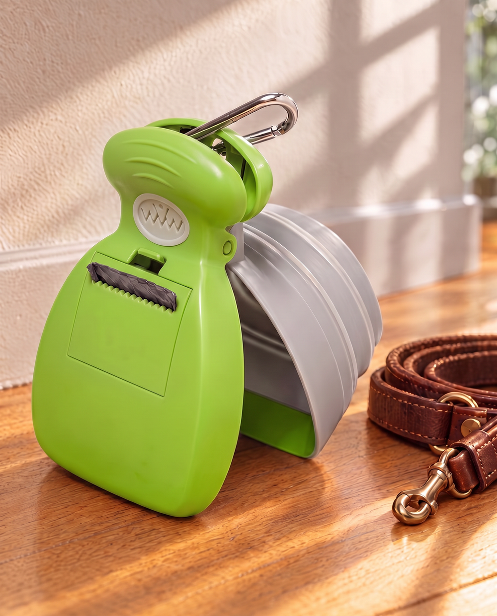 The pocket scooper in lime green with its bag roll and carabiner clip